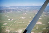 Landscape south of Silt, Colorado, pockmarked with gas wells, pads, pits, and roads